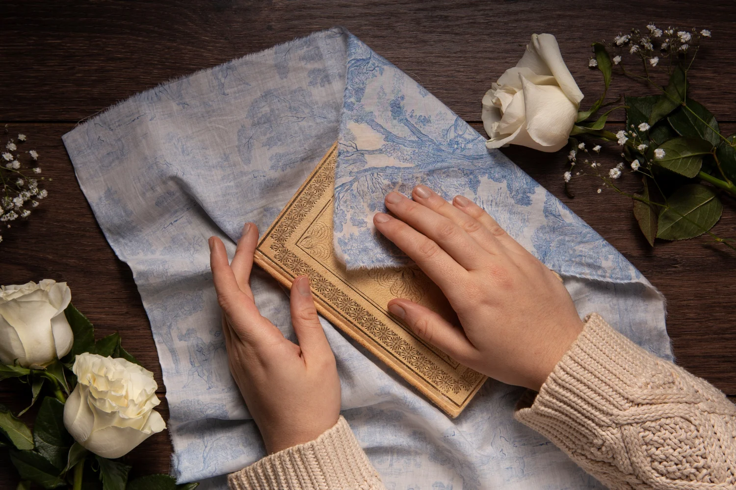 Close-up of wooden wall art being dusted with a soft cloth